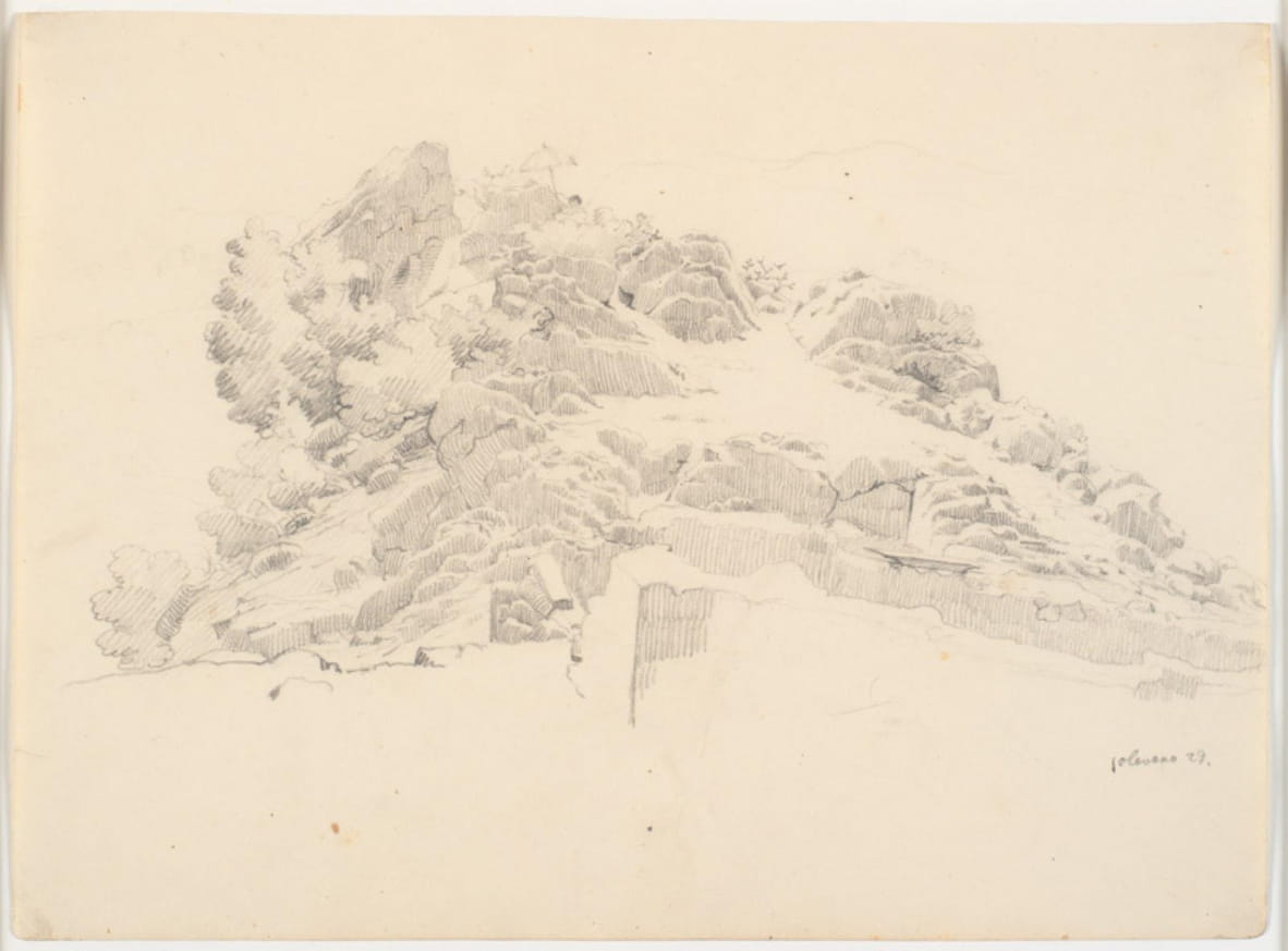 Section rocheuse avec un peintre sous un parasol