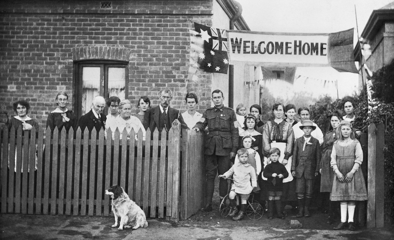 Portrait de groupe de 540 Sapeur Arthur Findon Dunbar MM, 2e Compagnie australienne de tunneliers (en uniforme avec son bras reposant sur la porte) et des membres de sa famille rassemblés devant leur maison au 45 Chief Street - Australian Photographer