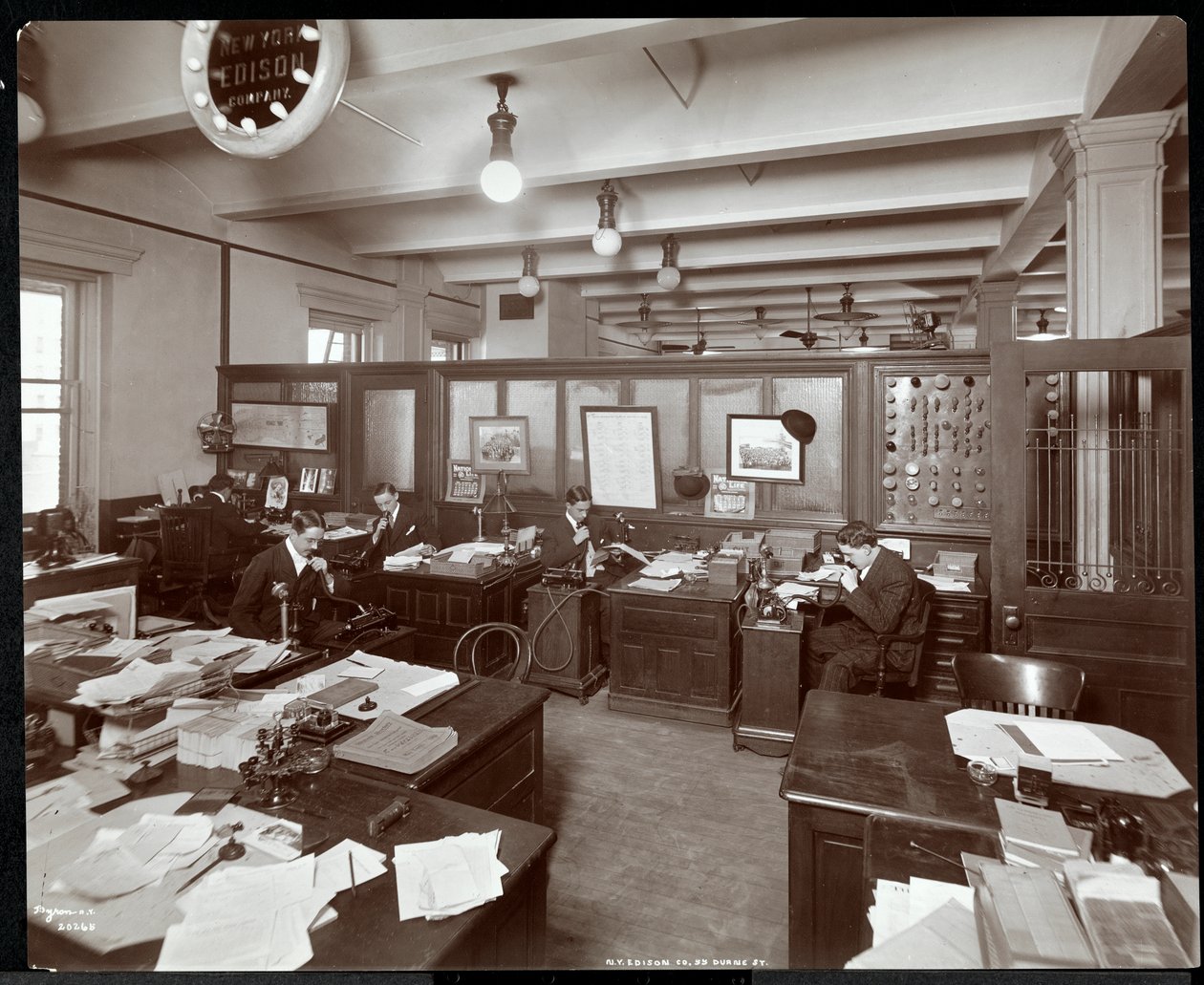 Vue intérieure des hommes utilisant des machines à dicter à la New York Edison Co. au 55 Duane Street, New York, 1905 (tirage à la gélatine argentique) - Byron Company