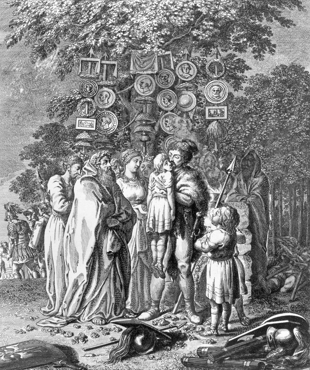 Devant un grand chêne, Hermann soulève le jeune garçon blessé, destiné au sacrifice, et l