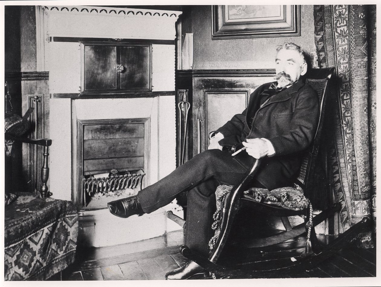 Stéphane Mallarmé (1842-98) assis près de la cheminée chez lui, rue de Rome, Paris - French School