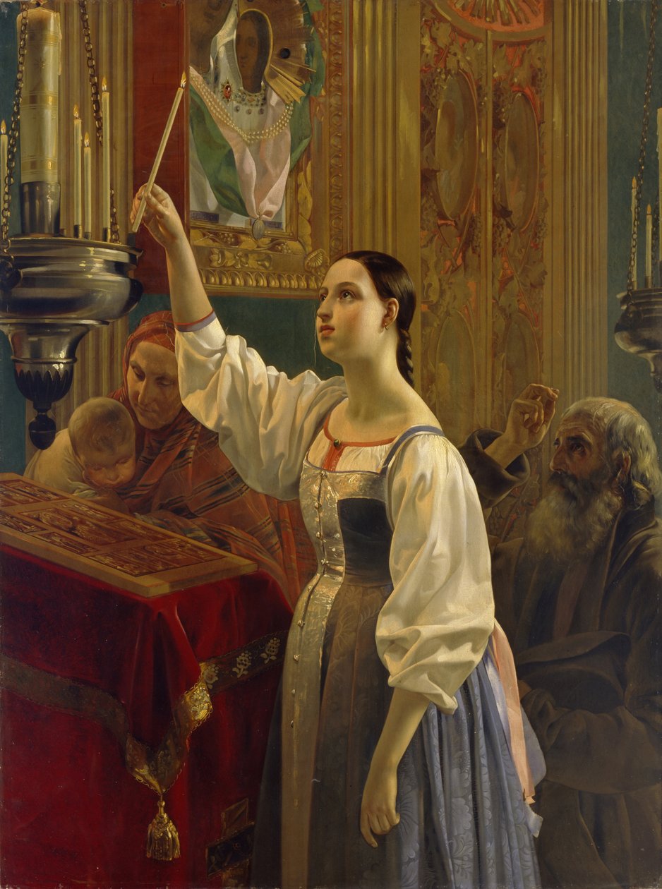 Une fille place une bougie devant l