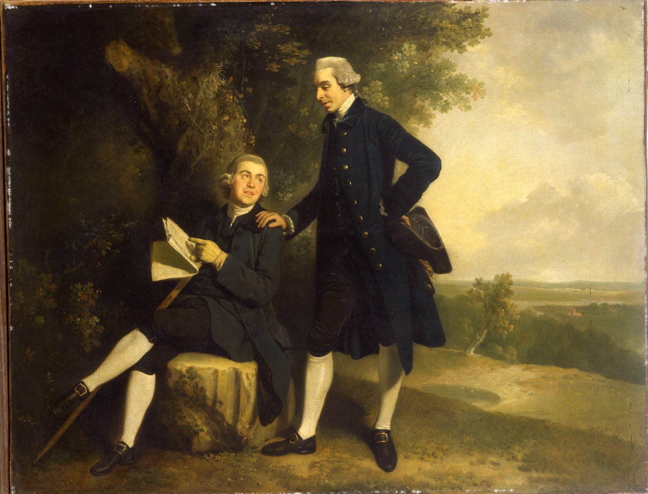 Double portrait de Thomas Somers Cocks et Richard Cocks de Castleditch, tous deux en pied, le premier en manteau et gilet bleu tenant un tricorne noir, le second assis en manteau et gilet bleu tenant un manuscrit, dans un paysage - John Hamilton Mortimer