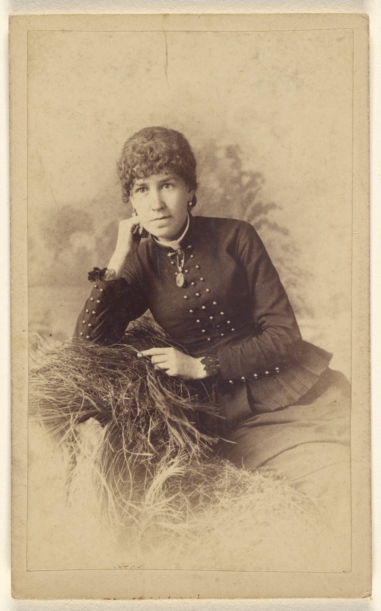 [Femme non identifiée assise, la main sur la joue, posée sur un tas de foin]. - Miller and Company