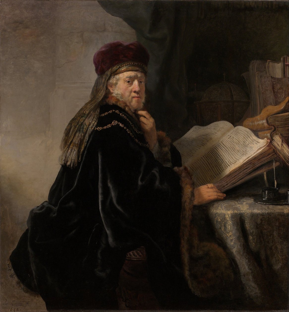 Un érudit assis à un bureau - Rembrandt van Rijn