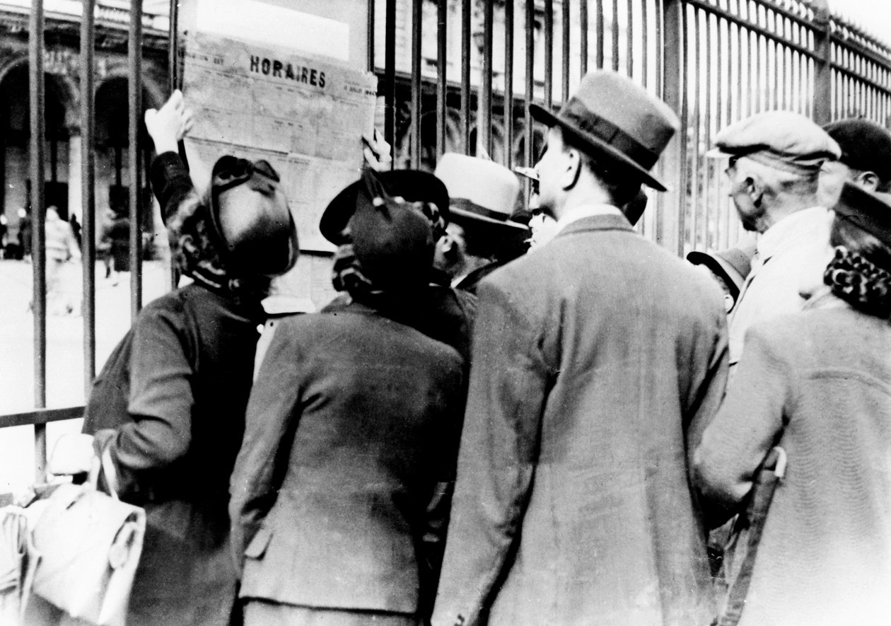 Réfugiés étudiant un horaire de train, Gare de l