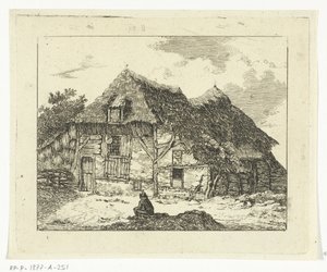 Homme assis sur une colline devant une maison à Staphorst