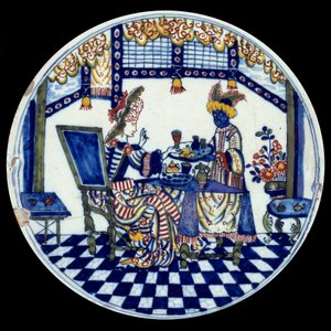 Assiette en porcelaine de Delft représentant une femme à une table servie par son serviteur noir. 1705 Sèvres, Musée National de la Céramique - Dutch School