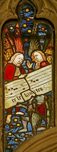 Fenêtre n2 représentant la chorale angélique avec une partition musicale