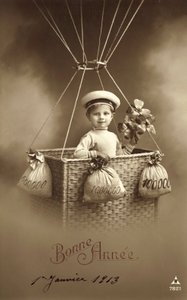 Carte de Nouvel An 1913, avec un garçon montant un ballon, avec beaucoup d