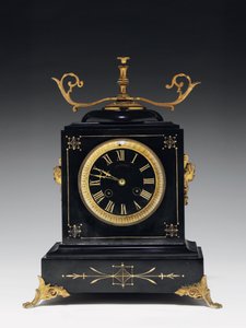 Pendule de cheminée en pierre noire, avec décoration incisée, avec pieds, ornements et accessoires en laiton doré, par Jausions de Pau, France, vers 1876-78 - French School