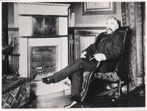Stéphane Mallarmé (1842-98) assis près de la cheminée chez lui, rue de Rome, Paris - French School