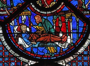 La fenêtre du Bon Samaritain : le Samaritain soigne l