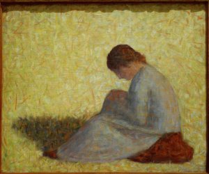Paysanne assise dans l’herbe