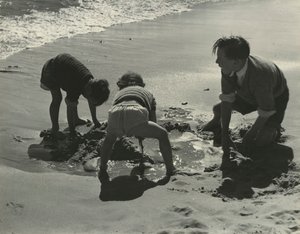 Trois enfants jouant avec du sable à la plage - Godfrey Macdominic