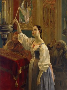 Une fille place une bougie devant l