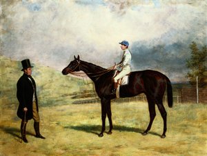 Un gentleman avec son cheval de course et un jockey sur un hippodrome