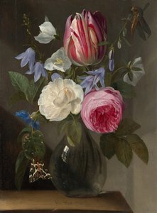Roses et une tulipe dans un vase en verre