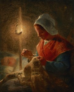 Femme cousant à la lumière d