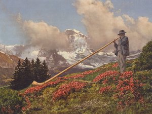 Suisse : Un joueur de cor des Alpes, la Jungfrau en arrière-plan