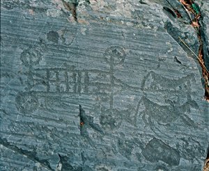 Préhistoire : civilisation camunienne : un char tiré par des chevaux, les roues sont représentées avec des rayons et les chevaux sont en profil dans une tentative de perspective. Gravure rupestre de la roche 23 par Naquane (Valcamonica, Val Camonica, Bresc - Prehistoric Prehistoric
