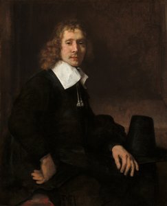 Un jeune homme assis à une table, possiblement Govaert Flinck, vers 1660 - Rembrandt van Rijn