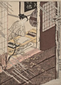 Une femme assise à un bureau regardant la pluie