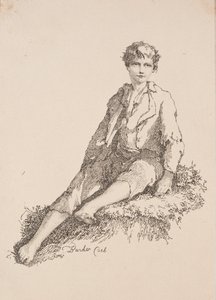 Garçon assis sur une berge herbeuse