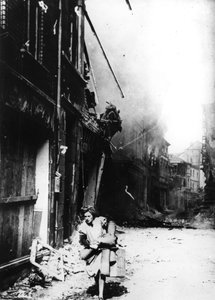 Une femme quittant sa maison en feu dans une rue bombardée, Allemagne, 1945 - Unbekannt