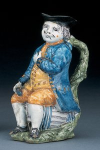 Cruche Toby avec visage et mains en manganèse pâle, tenant une cruche globulaire vide de couleur buff dans une veste et un pantalon bleu lavé, et un gilet vert, vers 1800 - Unbekannt
