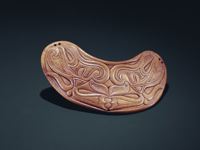 Plaque de selle à tête d