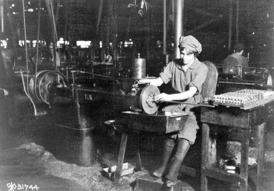 Femme perçant une rainure de clavette dans le porte-viseur avant pour fusil, Eddystone Rifle Plant, Eddystone, Pa., pendant la Première Guerre mondiale, 1914-18 - American Photographer