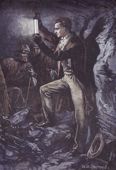 Humphry Davy avec la lampe de sûreté Davy pour les mineurs, inventée en 1815 (gravure sur bois coloriée à la main) - British School