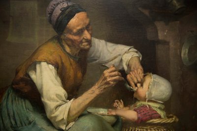 Une vieille femme nourrit sa petite-fille tenue dans un trotteur en osier - Edouard Jerome Paupion