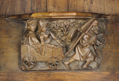 Sculpture représentant un couple dans une charrette tirée par un homme, d