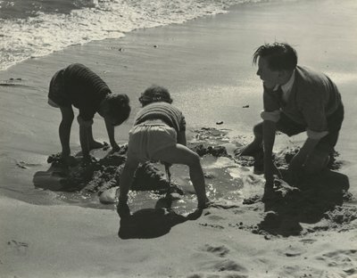 Trois enfants jouant avec du sable à la plage - Godfrey Macdominic