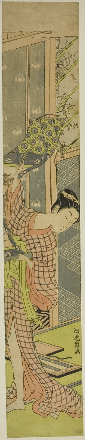 Jeune femme accrochant un tableau - Isoda Koryusai