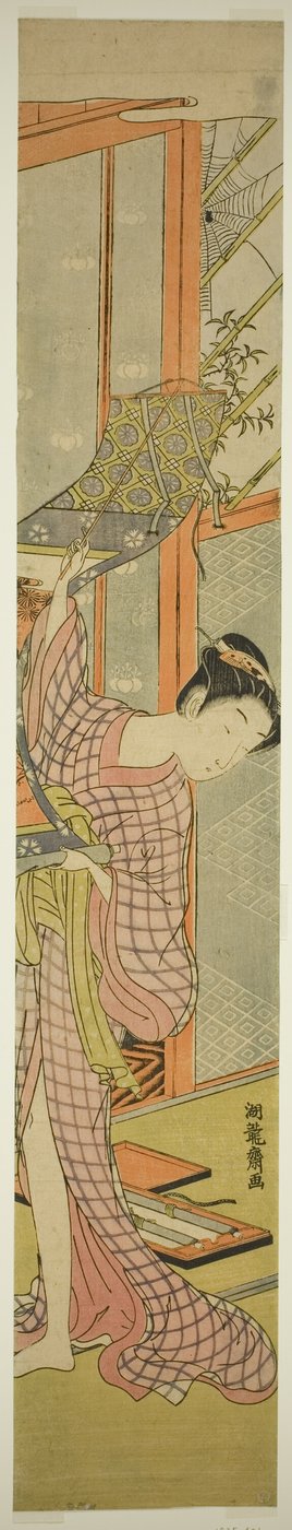 Jeune femme accrochant un tableau - Isoda Koryusai