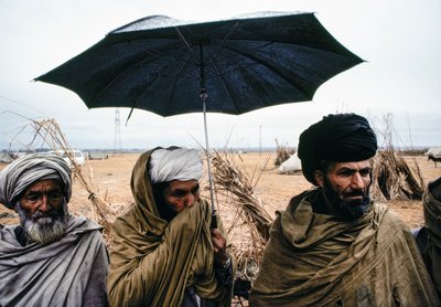 Hommes pakistanais avec un parapluie et des vêtements traditionnels - James L Stanfield