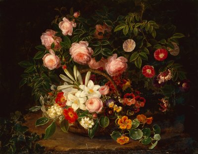 Un panier de roses, lys et pensées près d