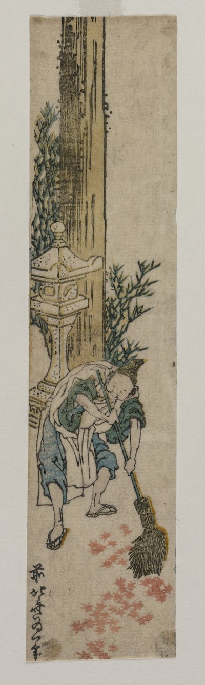 Attendant du sanctuaire ratissant des feuilles d