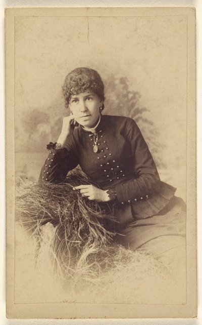 [Femme non identifiée assise, la main sur la joue, posée sur un tas de foin]. - Miller and Company