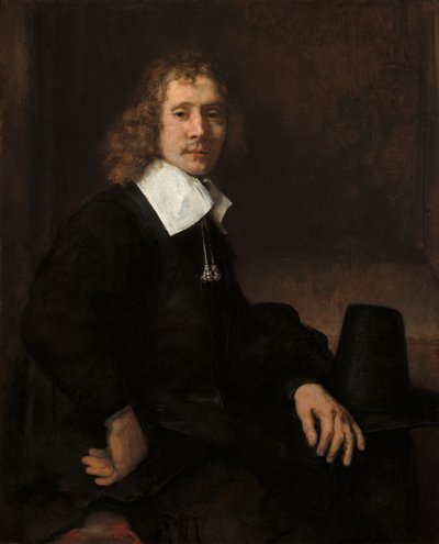 Un jeune homme assis à une table (peut-être Govaert Flinck) - Rembrandt van Rijn