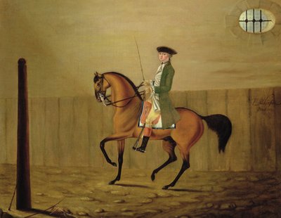 Gentleman sur un cheval bai dans une école d