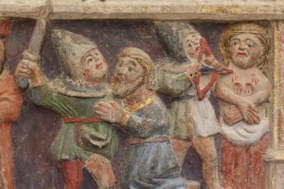 Retable. pierre polychrome. Seconde moitié du XIVe siècle. Origine ancienne église paroissiale de Torre de Rialb. Détail. Registre moyen. Panneau gauche. Partie inférieure : un officiel regarde la scène de la décapitation de Saint Iscle et de l