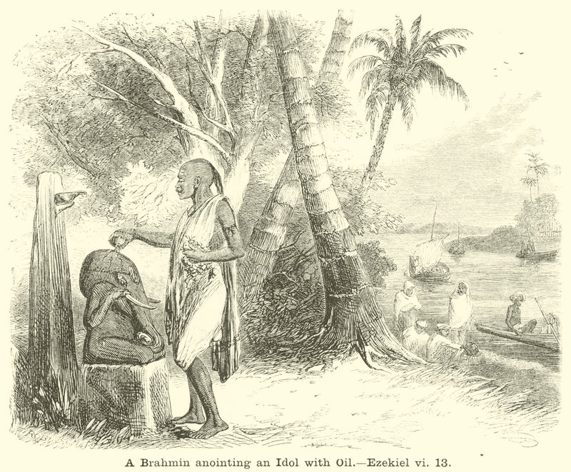 Un brahmane oint une idole avec de l