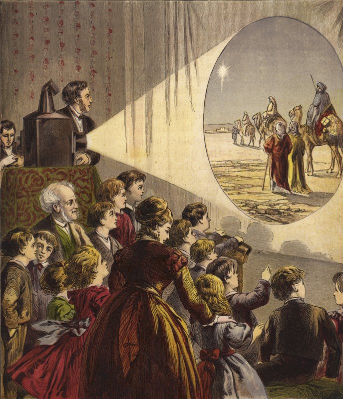 Enfants regardant un spectacle de lanterne magique sur l