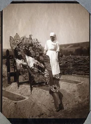Première Guerre mondiale 1914-1918 : infirmière (Thérèse Pavillou ?) en blouse sur la tombe du sergent pilote français Roux, mort à 21 ans, à Couville, Manche, Basse-Normandie, France. Photographie anonyme juillet 1917. Collection privée, Stella.