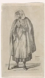 Femme avec un manteau et un bâton