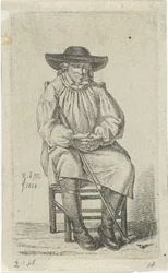 Homme assis avec bâton